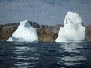 melting ice on rocks in sea